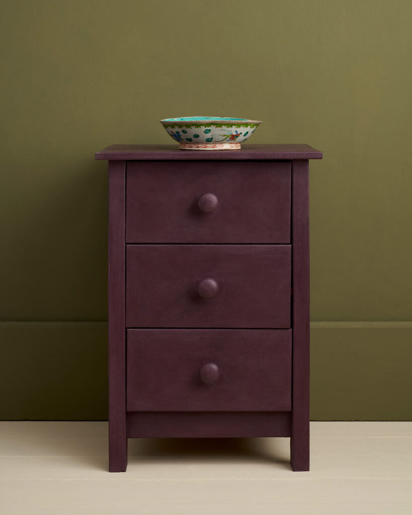 Tyriean Plum painted Purple dresser with three drawers against a green wall