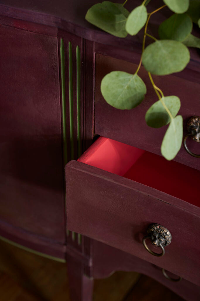 Close-up of a wooden drawer with a painted in Tyrian Plum Annie Sloan chalk paint shop online at Palette and patina